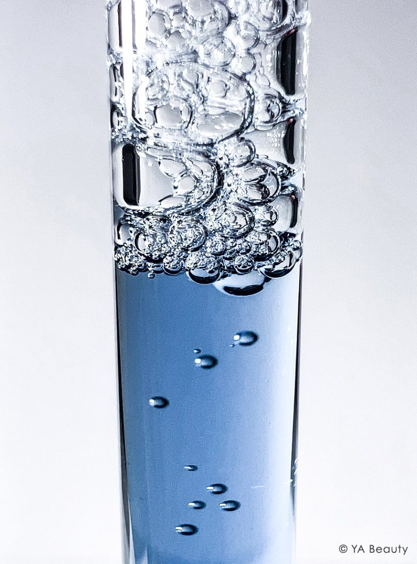 Closeup macro photography of blue liquid in a dropper with bubbles and foam. Featuring kbeauty brand Dear Klairs's Midnight Blue Youth Activating Drop Serum