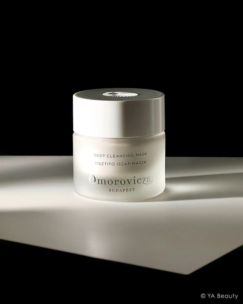 Omorovicza Deep Cleansing mask photographed editorially on a dramatic black and white background.