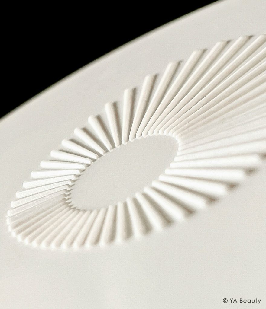 Omorovicza Deep Cleansing mask logo photographed editorially closeup, on a dramatic black background.