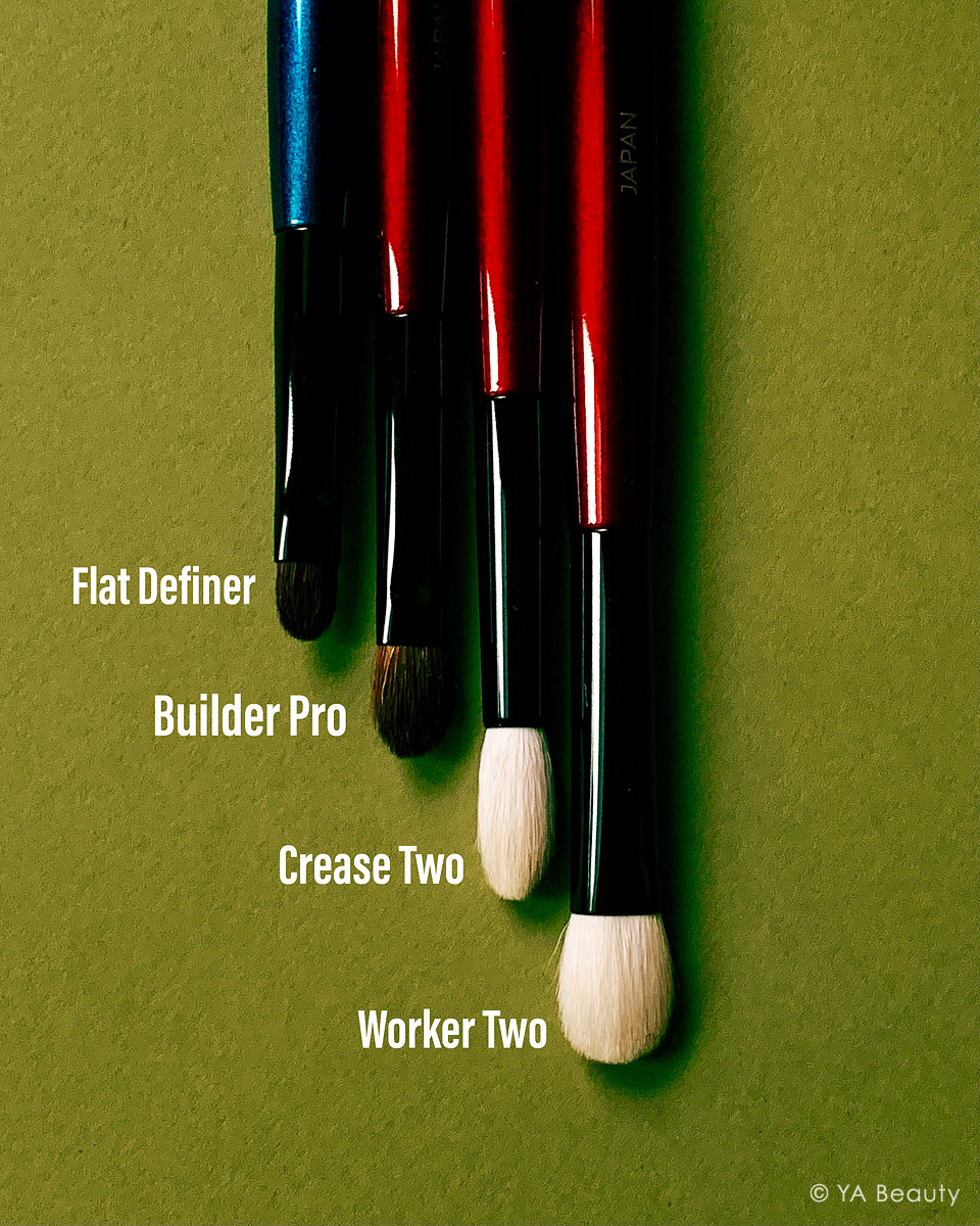 Sonia G makeup brushes Flat Definer, Builder Pro, Crease Two, Worker Two, photographed on a deep green background