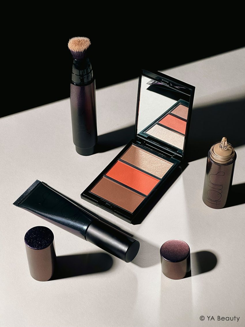 Surratt Beauty flatlay featuring Dew Drop Foundation, Plus de Soleil Blush and Face Palette, Surreal Skin Foundation Wand, and Perfectionniste Primer