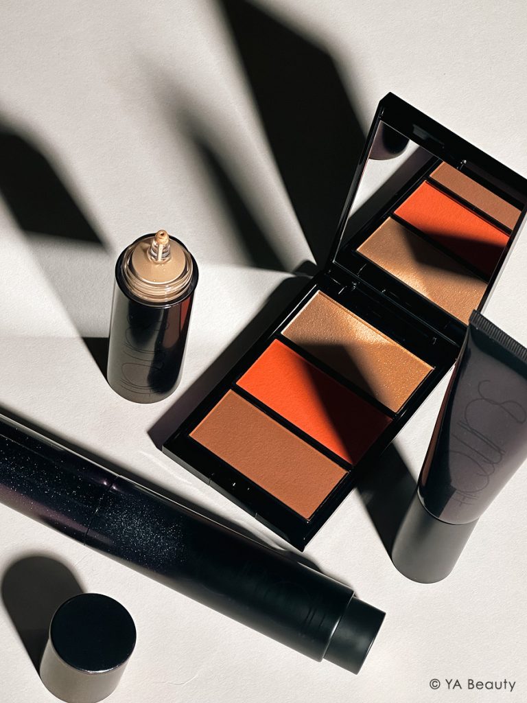 Surratt Beauty flatlay featuring Dew Drop Foundation, Plus de Soleil Blush and Face Palette, Surreal Skin Foundation Wand, and Perfectionniste Primer