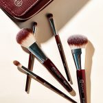 BK Beauty Travel Brush Set featuring the travel version of T101 Contoured Foundation Brush, T107 Flat Blush Brush, T202 Defined Crease Brush, T203 Eyeshadow Shader Brush, and T207 Pencil Blender Brush, as well as a vegan leather pouch in oxblood red color